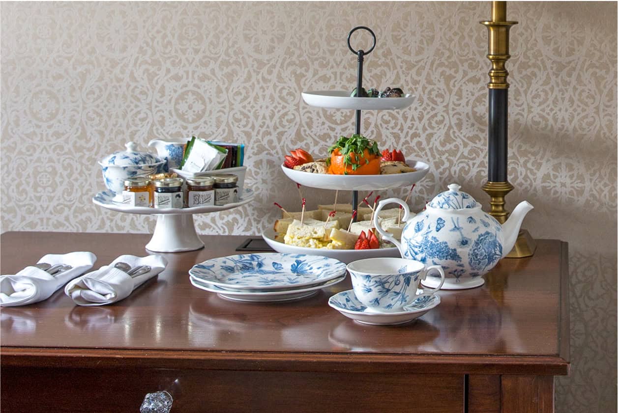 Finger Foods, a Teapot, and Teacups on a Bedside Table