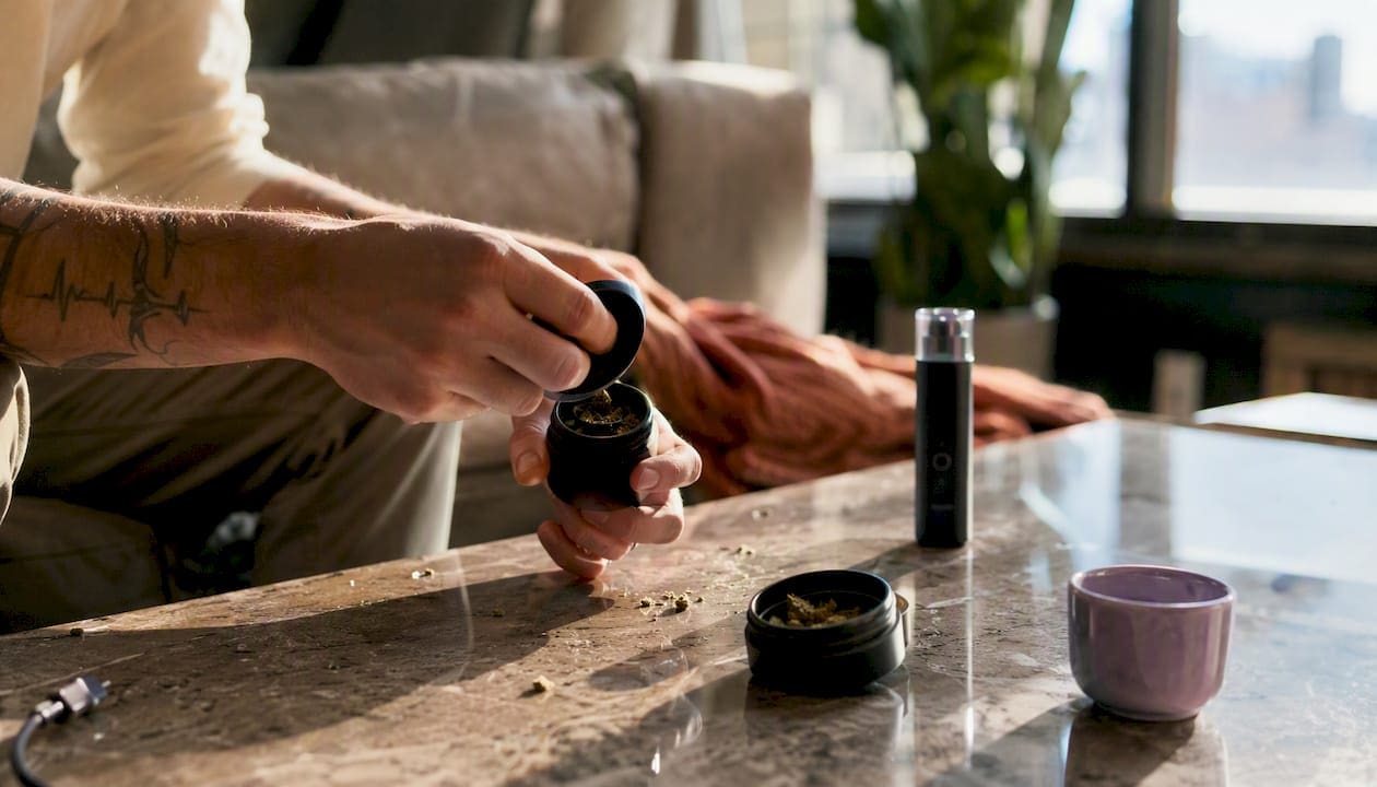Hands grinding dry herb for vaporizer session