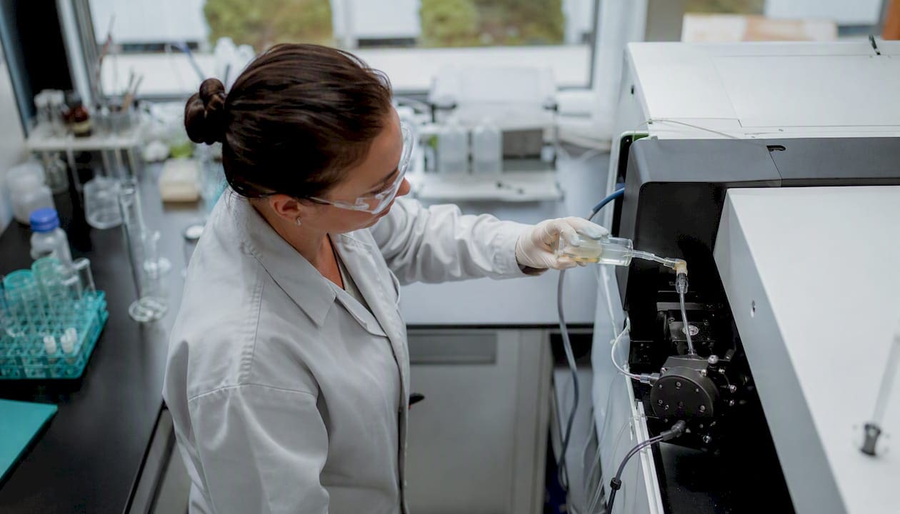 Technician pouring cannabis sample into ICP-MS instrument