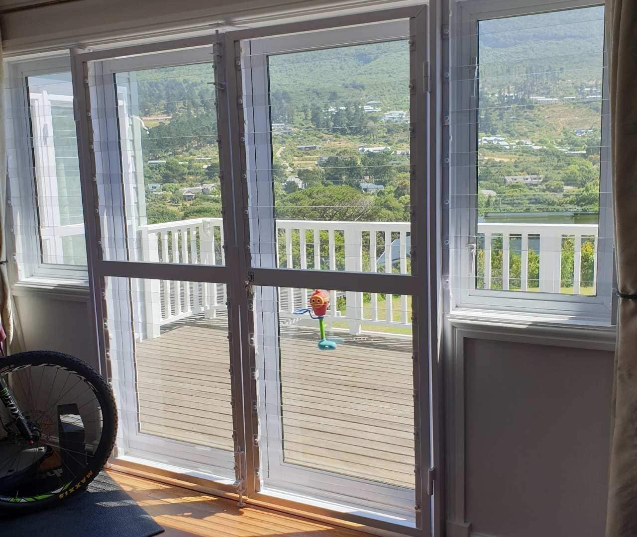 Indoor scene showing clearview gate on full-height doors, providing unobstructed outlook and added child-safe protection.