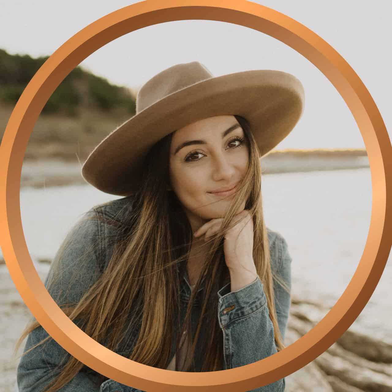 Relaxed woman wearing a wide-brim hat on the beach, enjoying her vacation in Florida.