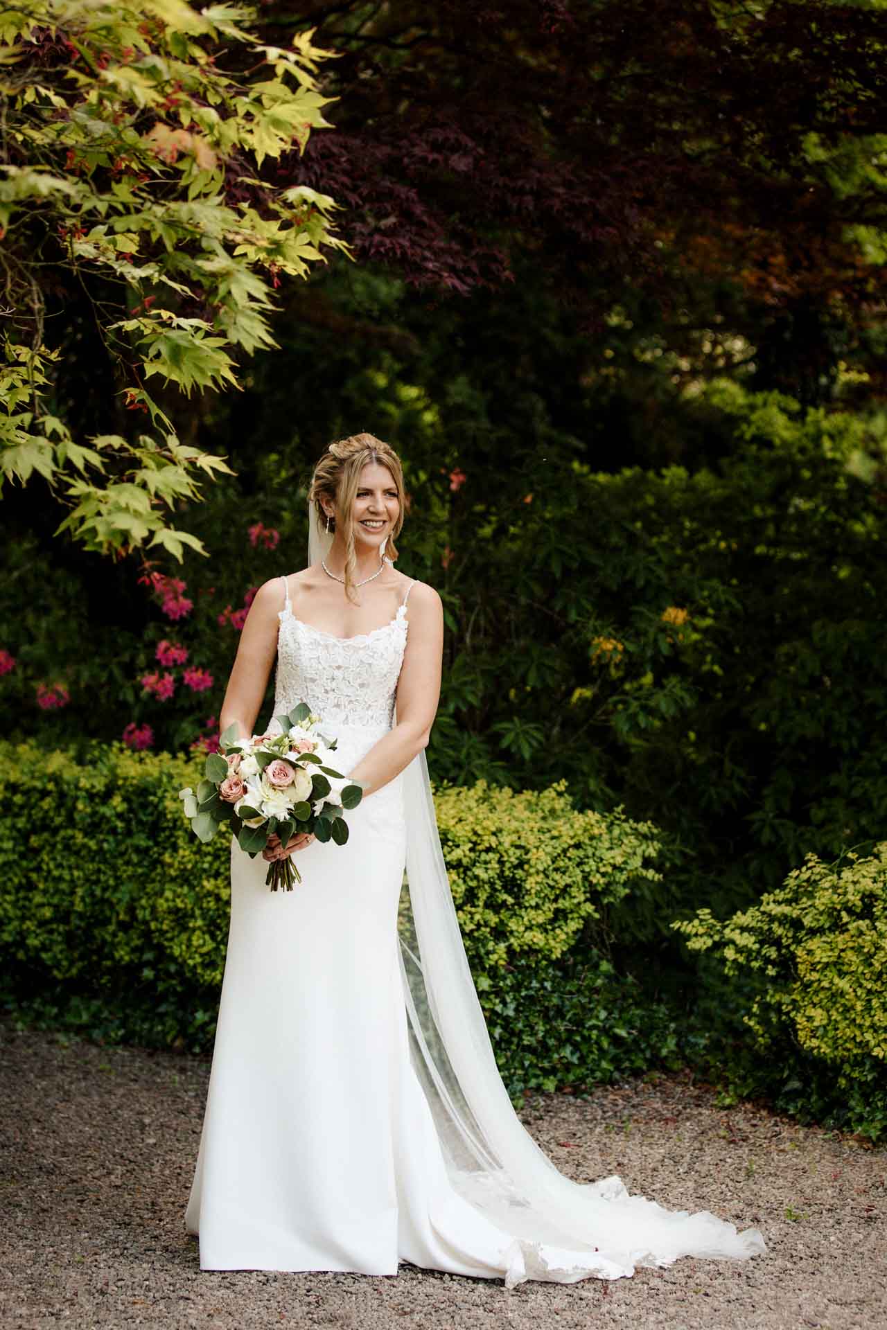 bride and groom portraits in the gardens at eaves hall lancashire