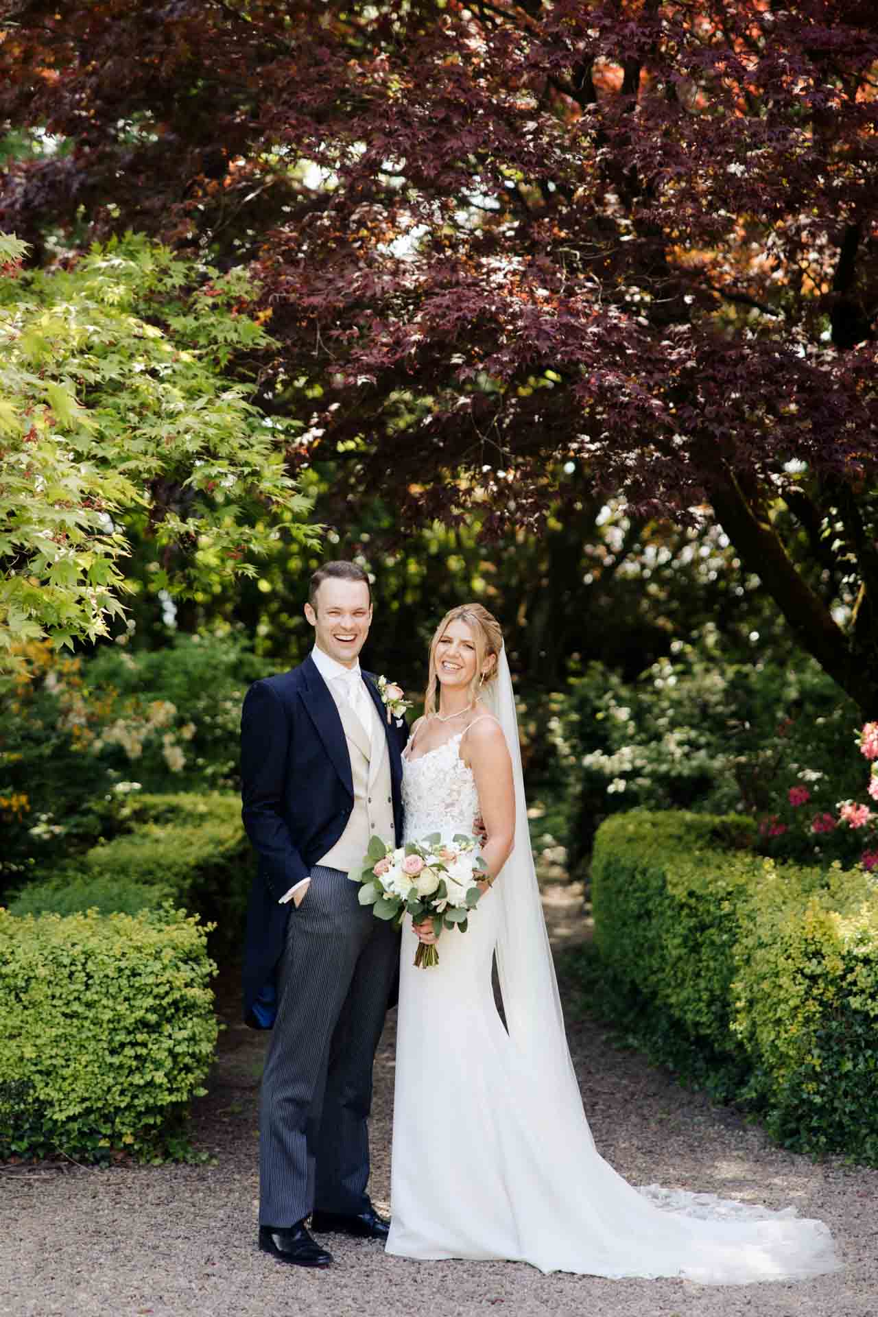 bride and groom portraits in the gardens at eaves hall lancashire