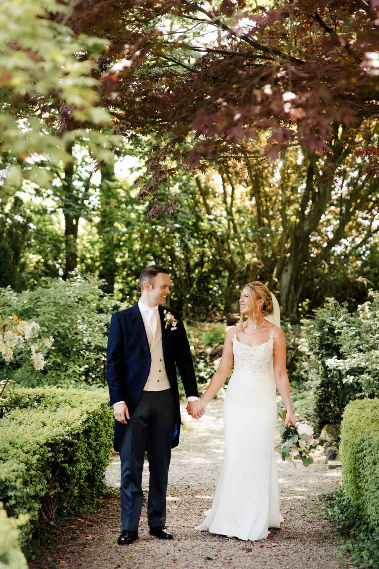 bride and groom portraits in the gardens at eaves hall lancashire