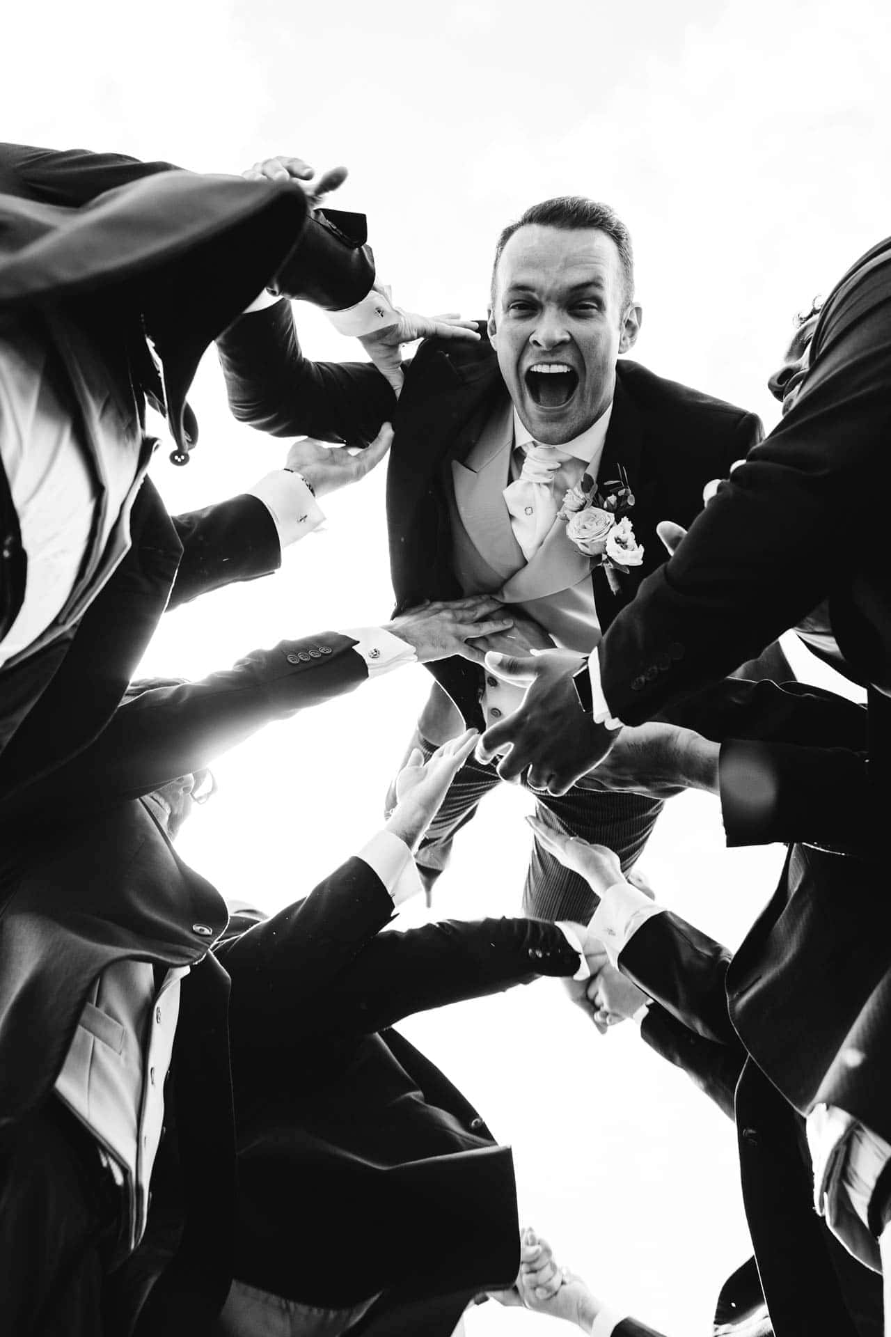 fun groomsmen photographs at eaves hall in lancashire