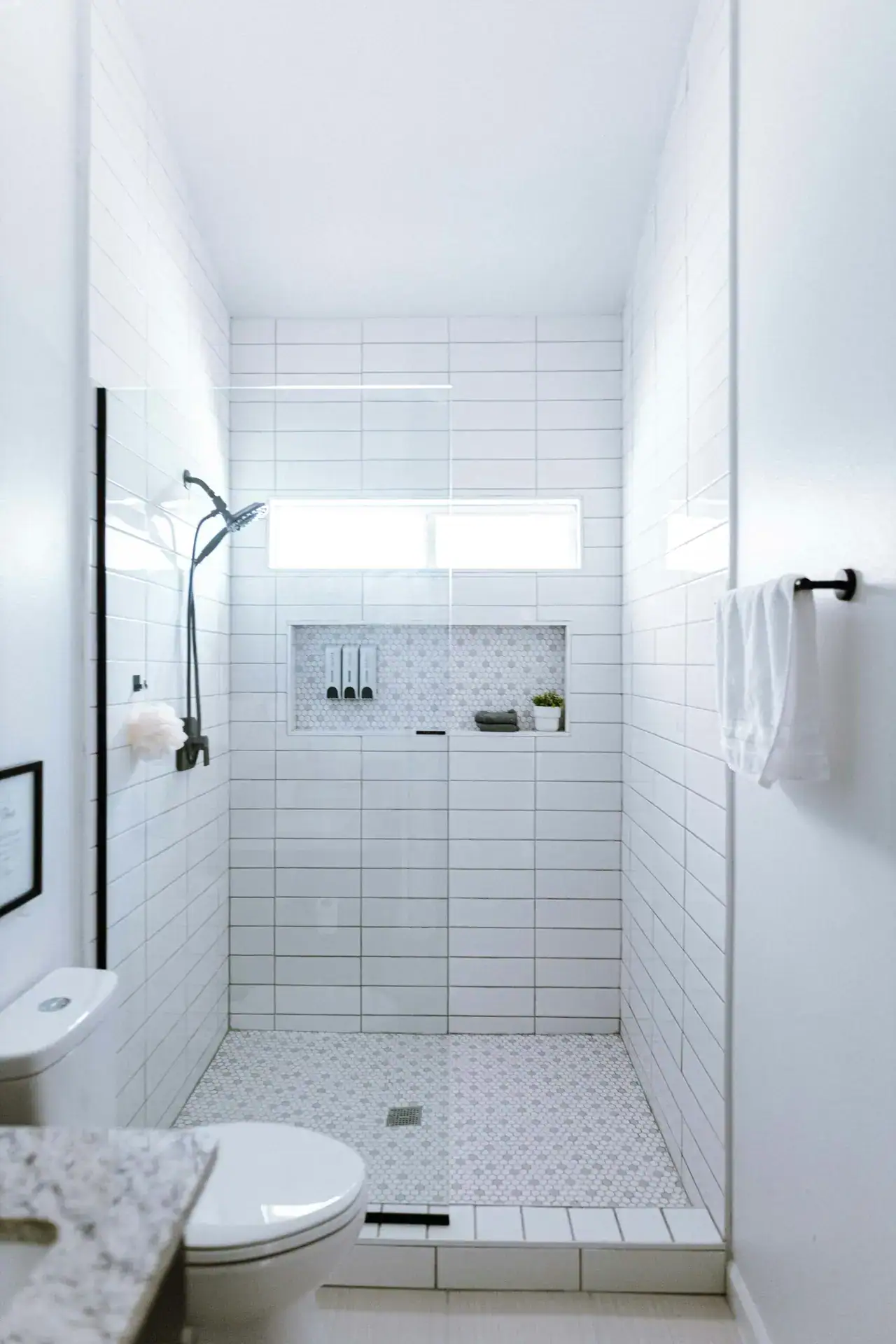 Small bathroom renovation trends 2026 featuring a floating vanity, freestanding tub, and large format tile flooring