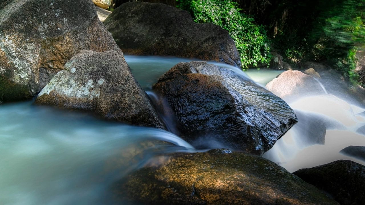 image of river water flowing over a variety of rocks