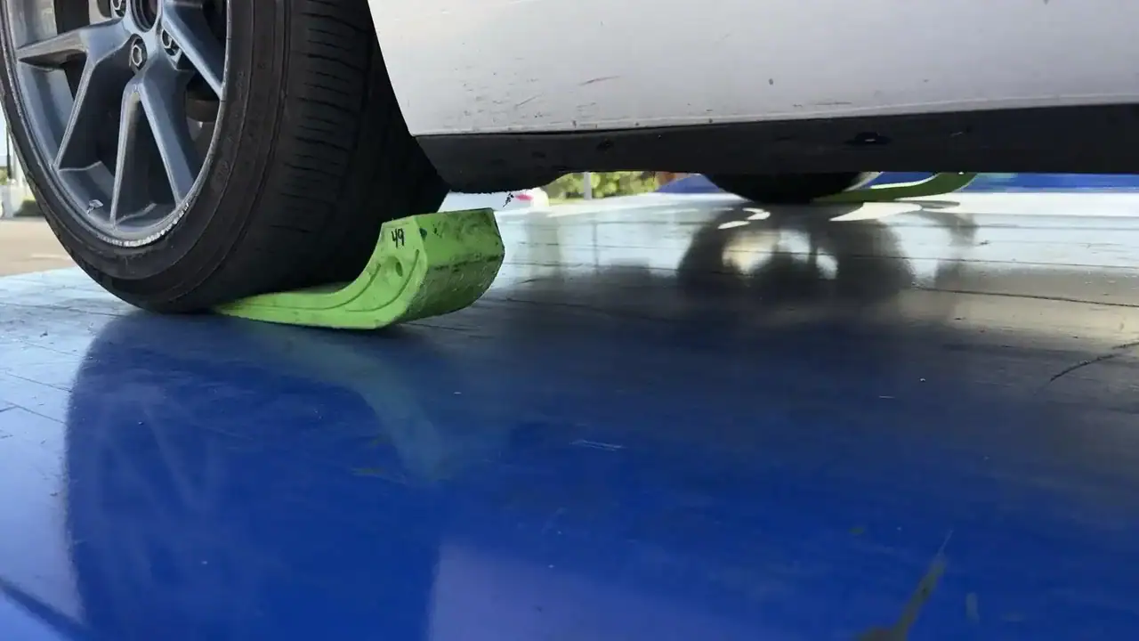 Tesla rear tire on a tow skate being loaded onto a flatbed to prevent wheel spin and protect the EV drivetrain