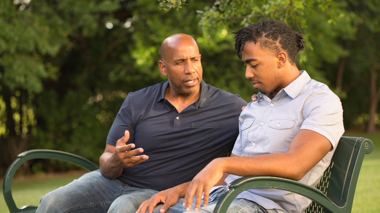 Mature man mentoring and giving advice to a younger man.