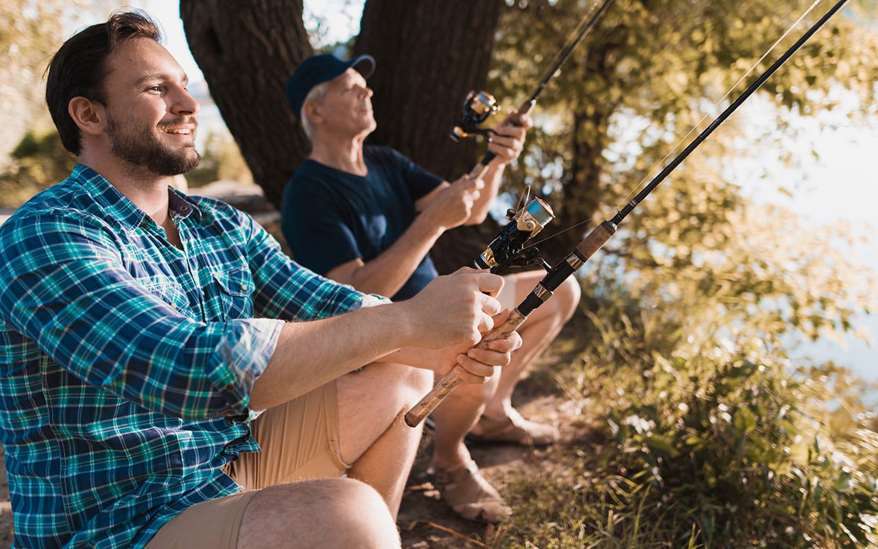 Older Father Fishing With Middle Aged Son