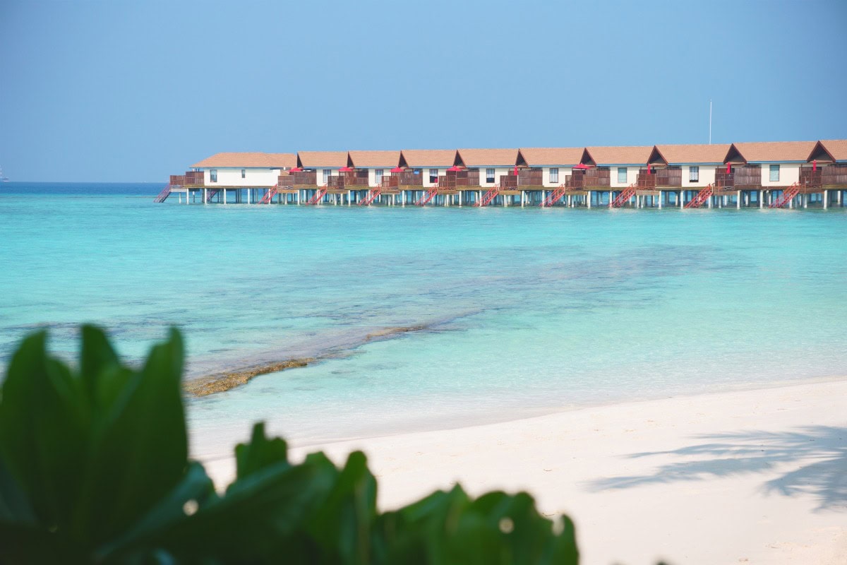 View of Reethi Faru Resort water villas and surrounding lagoon