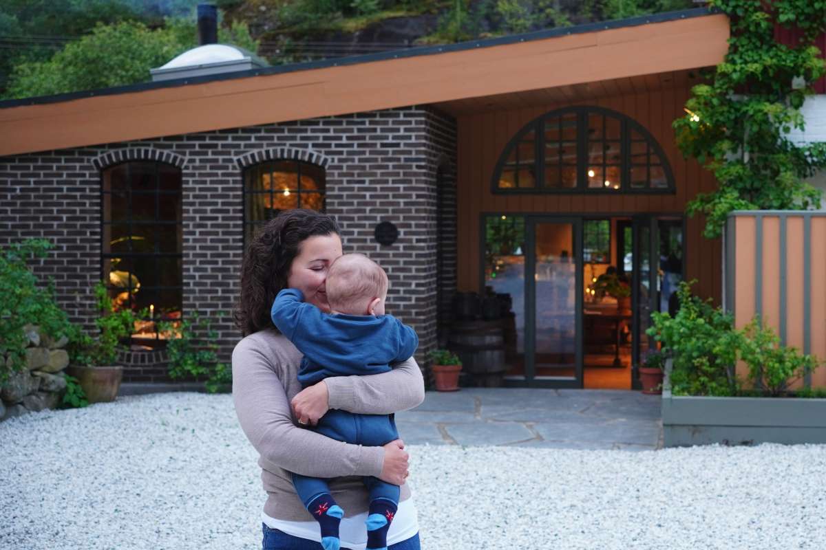 Mother and child in a restaurant courtyard in aurland, norway