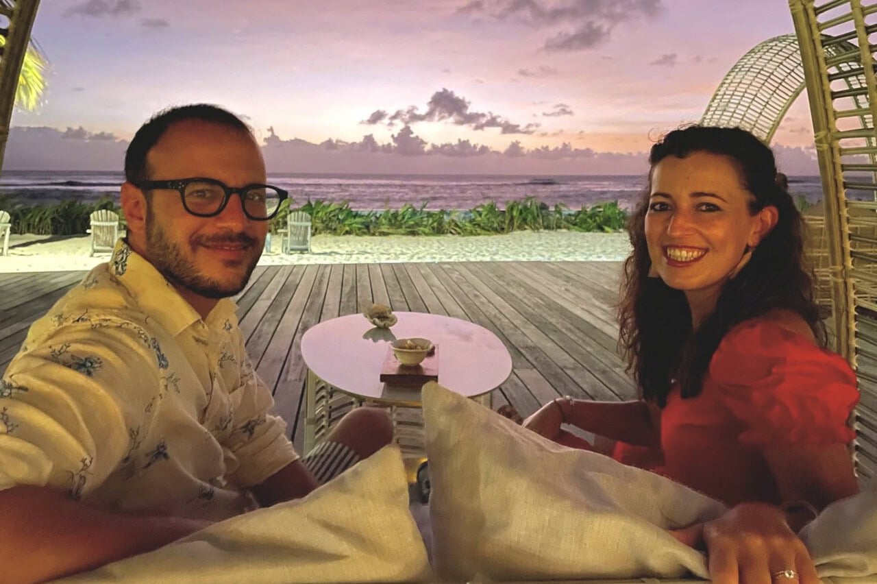 sunset_denis_patio Couple watching sunset by a wooden deck at the beach