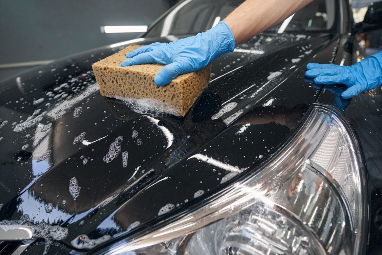 Turbo Mobile Detailing employee performing an exterior detail on a black car