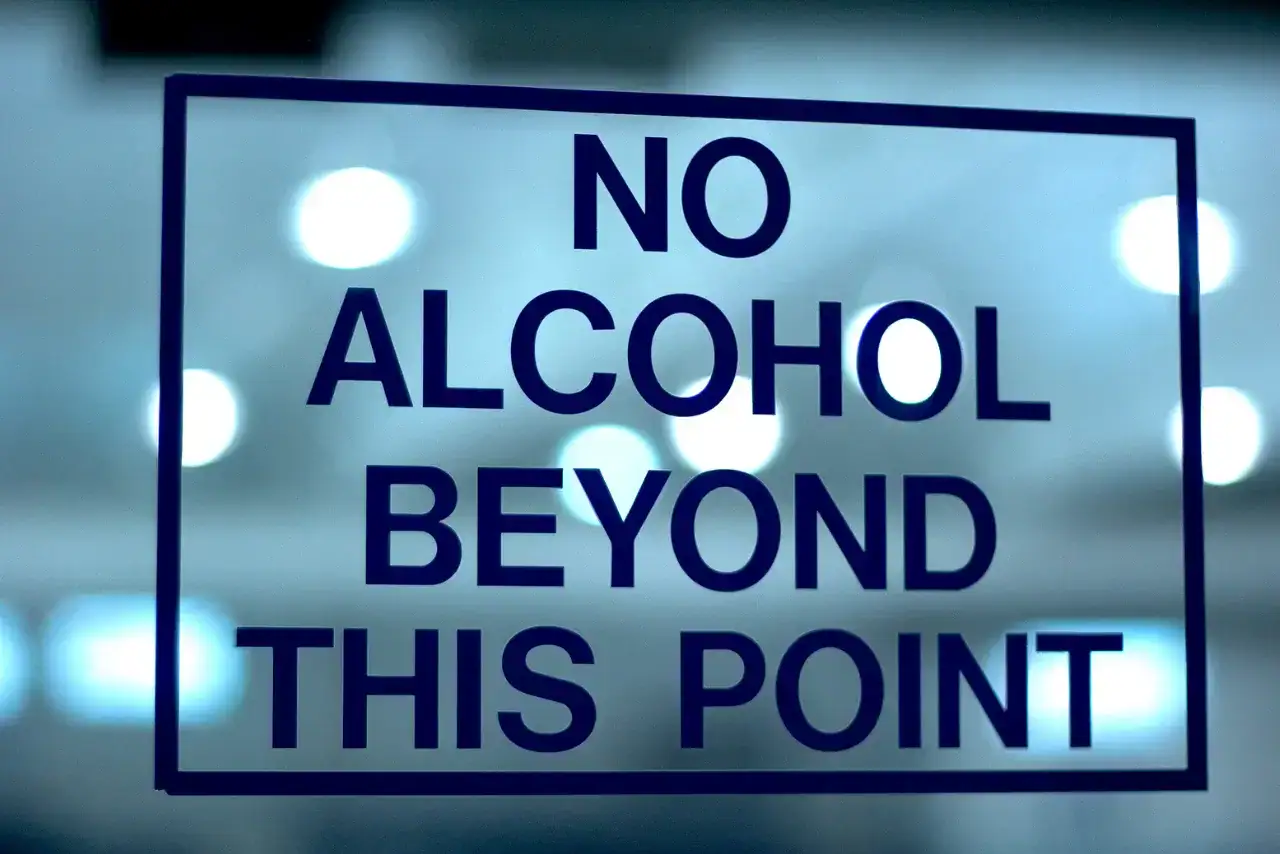 A sign at a business office that says no alcohol beyond this point