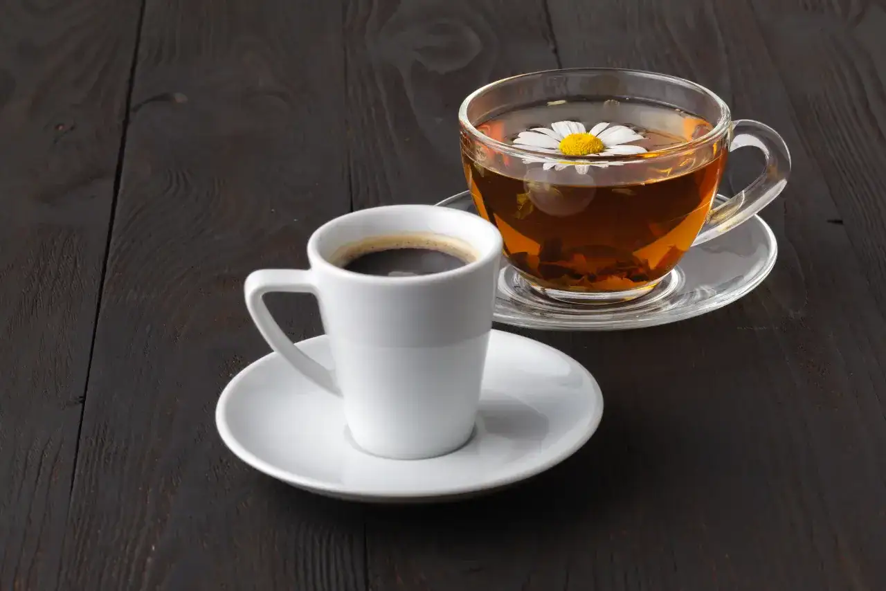 A cup of tea beside a cup of coffee