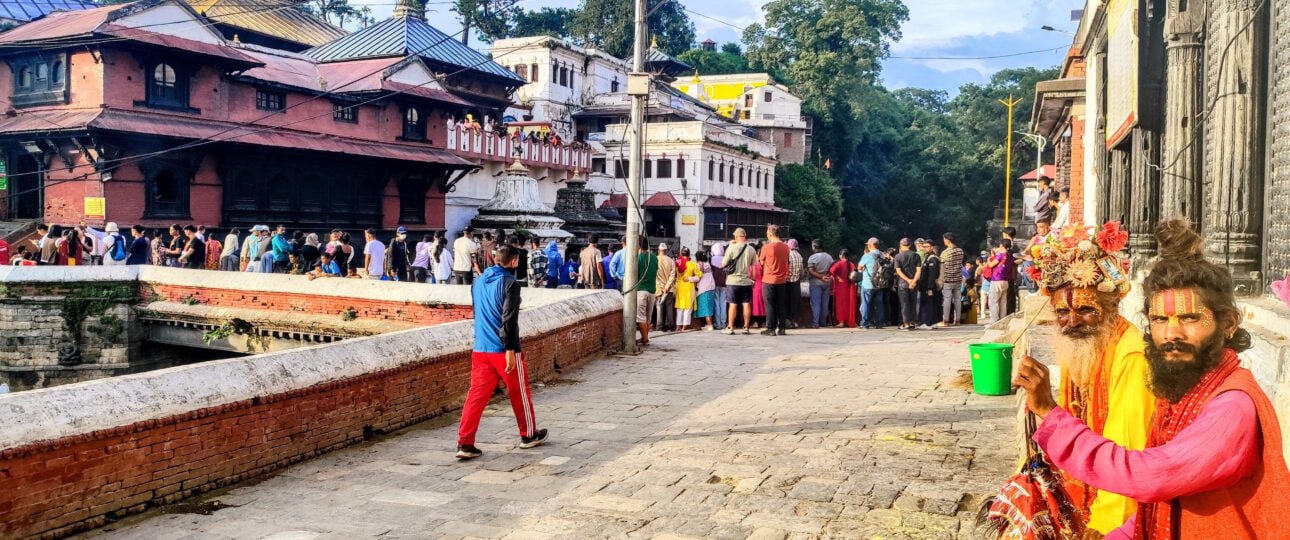 Two colorful sadhus sitting in front of Pashupatinath Temple in Kathmandu, Nepal
