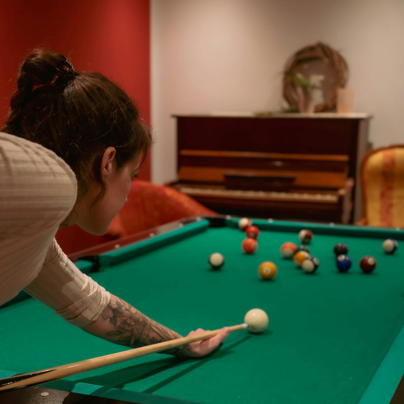 woman playing billiards in a cozy room setting