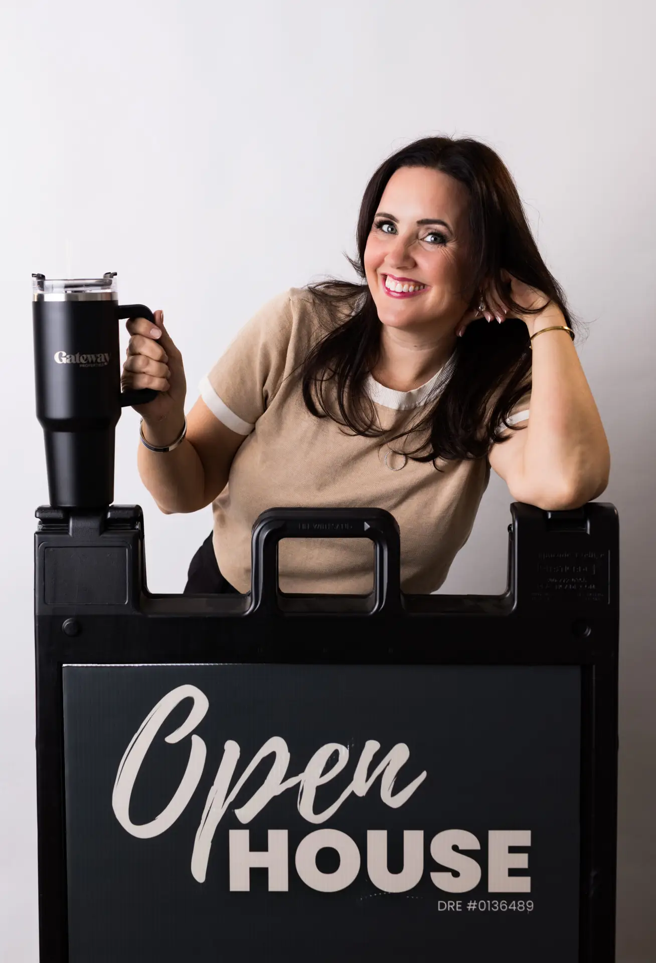 Jaydee Sheppard Realtor smiling behind an Open House sign in Roseville, Lincoln, Rocklin, and nearby Placer County cities