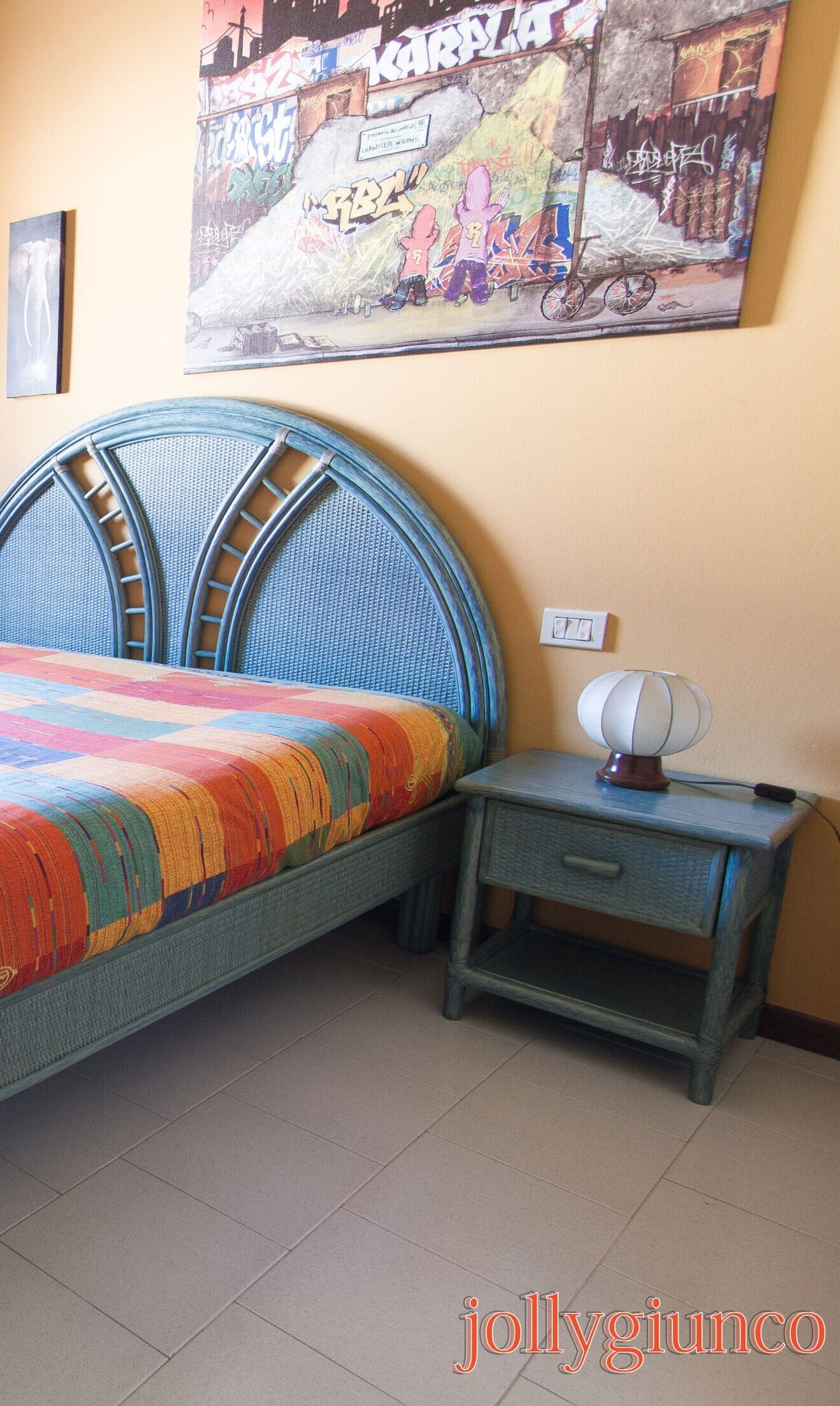 Letto in legno blu con testiera in vimini, soggiorno accogliente.