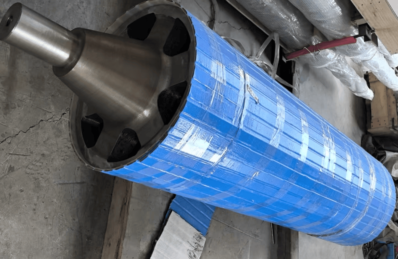 Large furnace roll with blue protective wrapping and its circular end visible