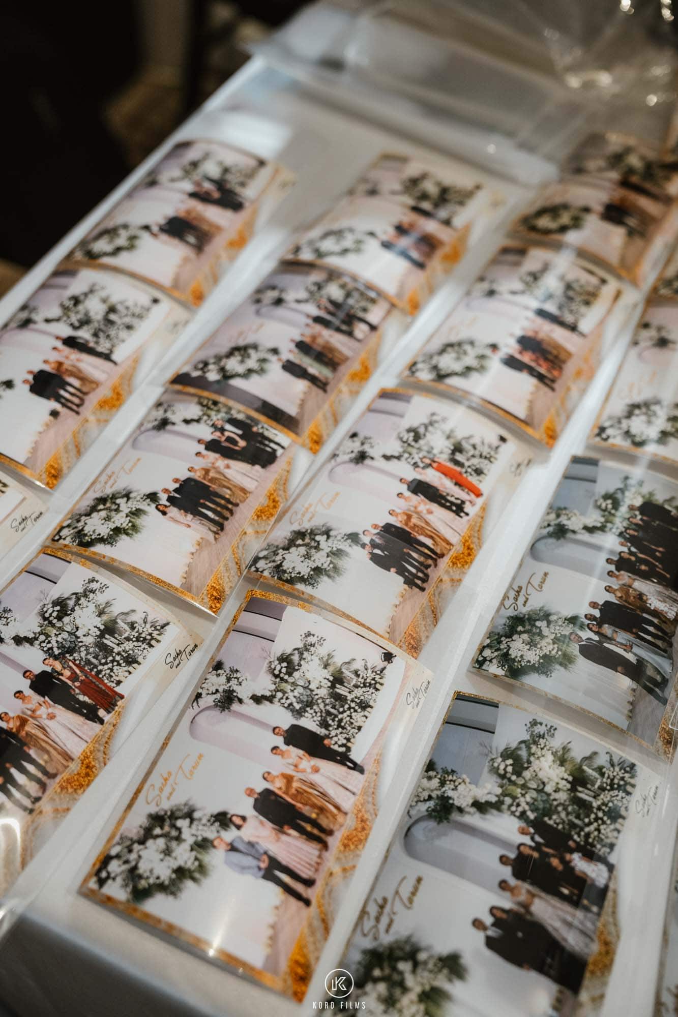 Rows of robot photo booth prints in clear sleeves laid out for guests to collect
