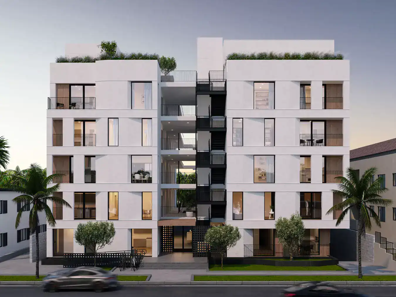Contemporary white stucco residential building with symmetrical design and large glass windows. Open balconies with black metal railings, rooftop gardens, and lush landscaping.