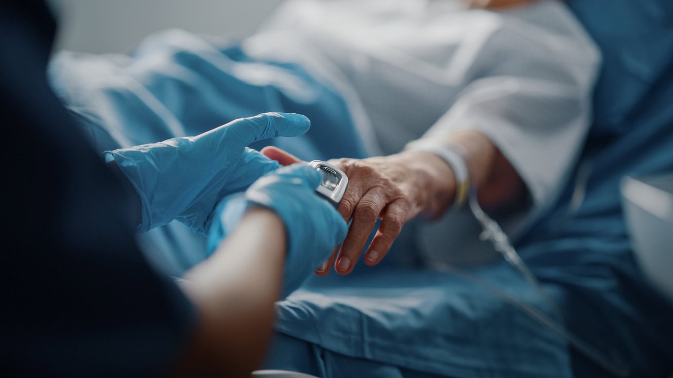  Pulse Oximeter showing Pulse. Anonymous Nurse Checks Vitals of Woman Getting well after Surgery