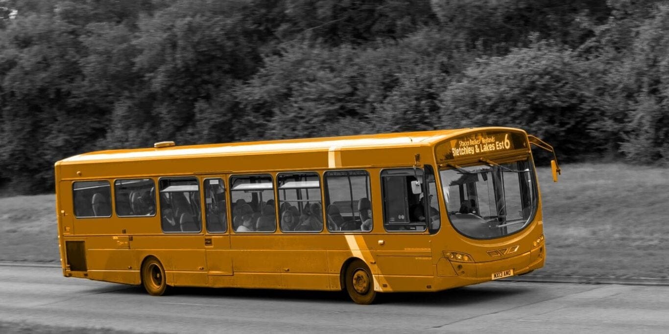 A bus driving down a road