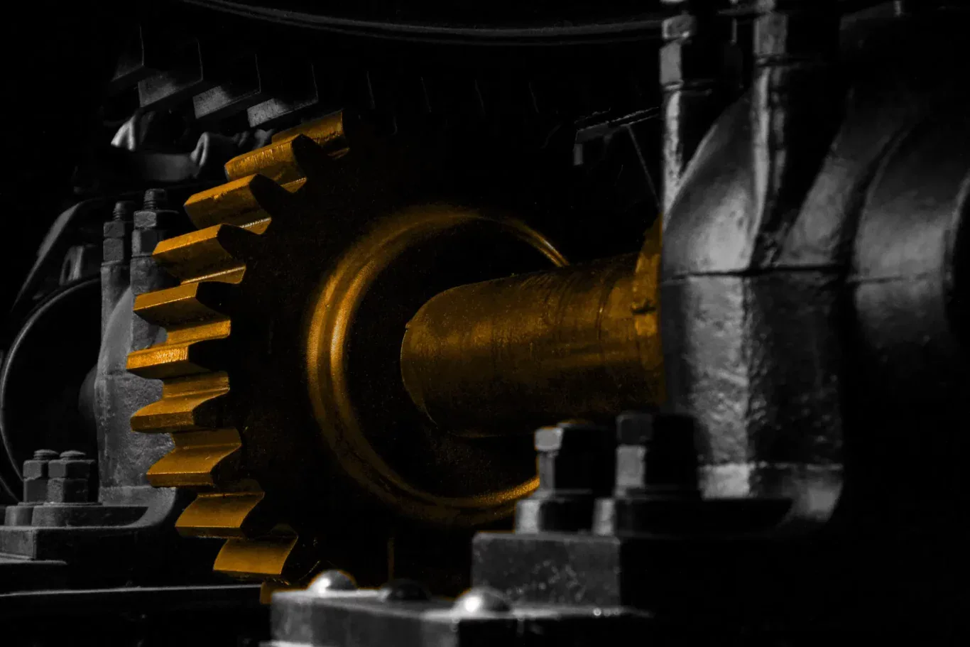 A bunch of black and white gears, with a orange cog in the middle