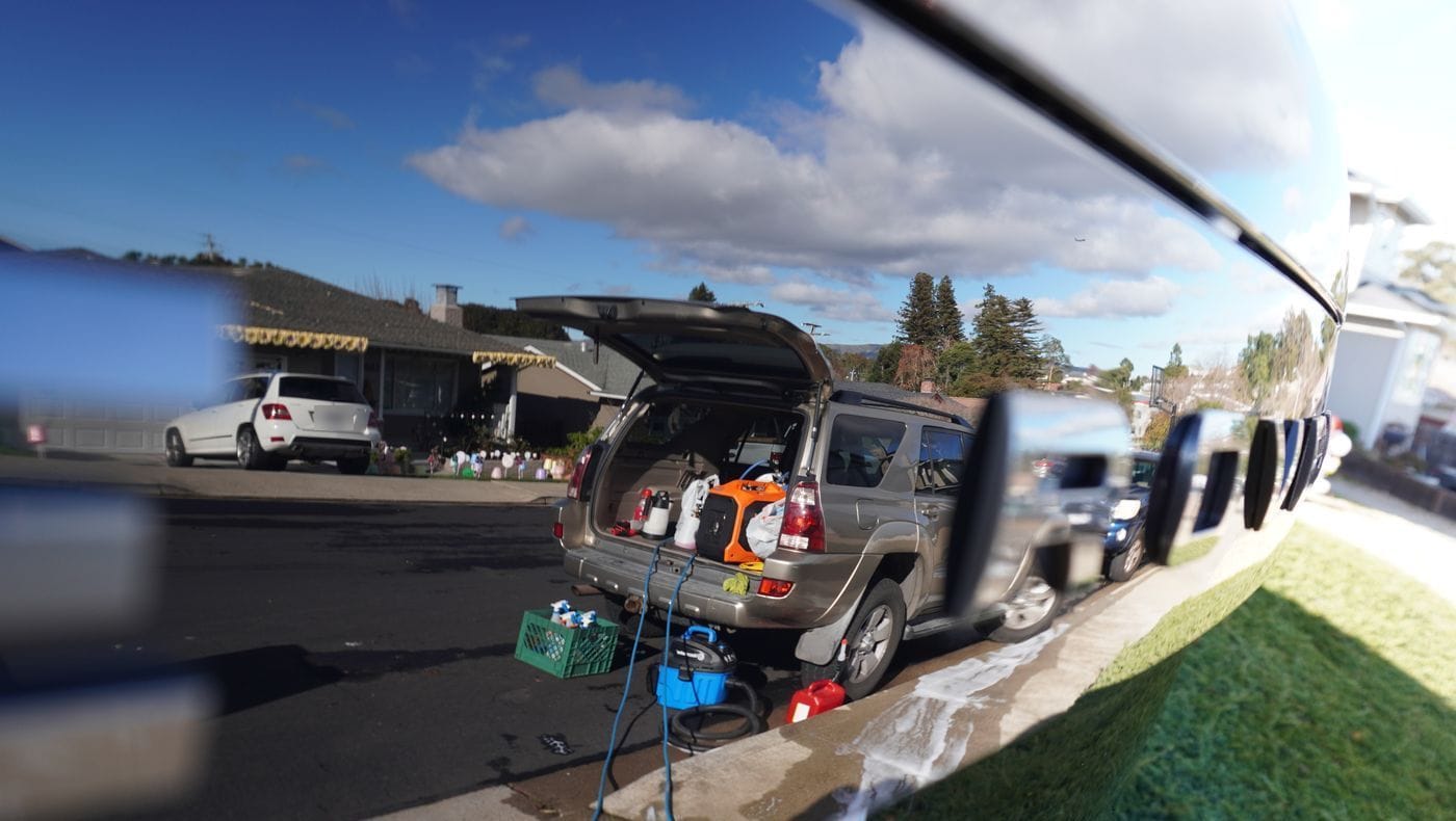 Guillermo's 4Runner and detailing gear reflected in a freshly detailed car