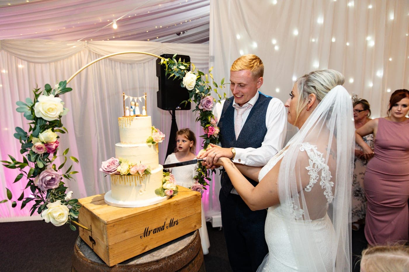 cutting the wedding cake at heaton house farm