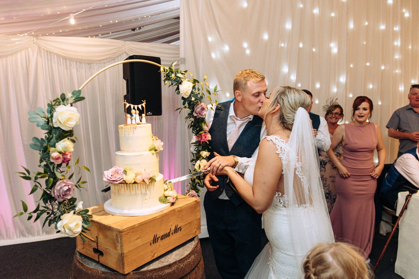 cutting the wedding cake at heaton house farm