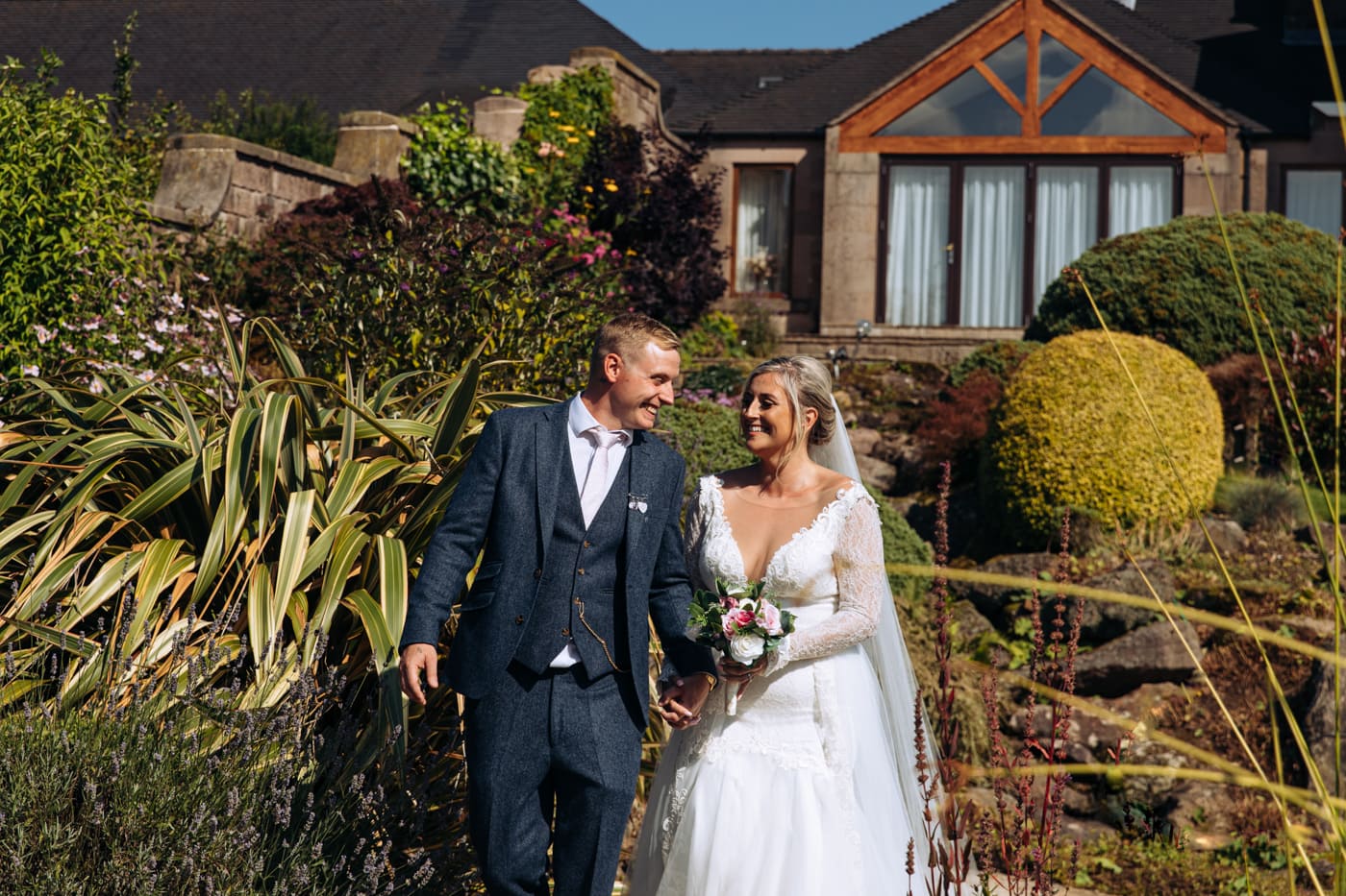 bride and groom enjoying their wedding photography at heaton house farm