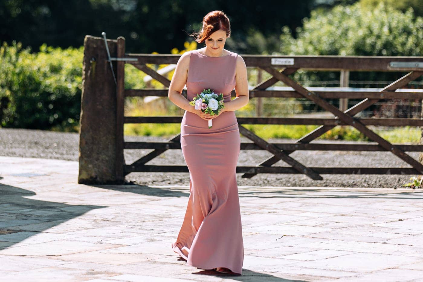 an outdoor ceremony with the bride walking down the aisle to get married at heaton house farm