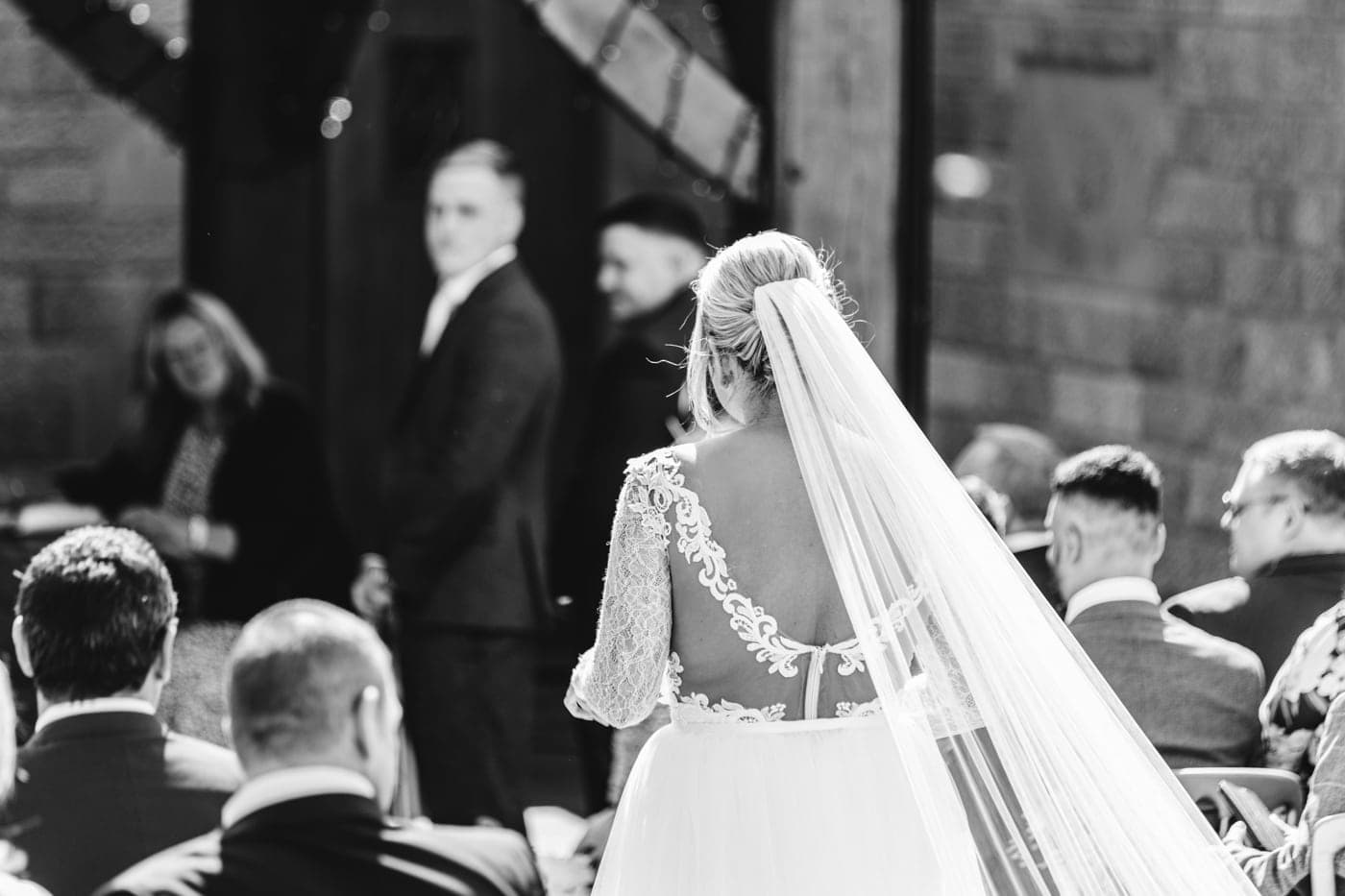 an outdoor ceremony with the bride walking down the aisle to get married at heaton house farm