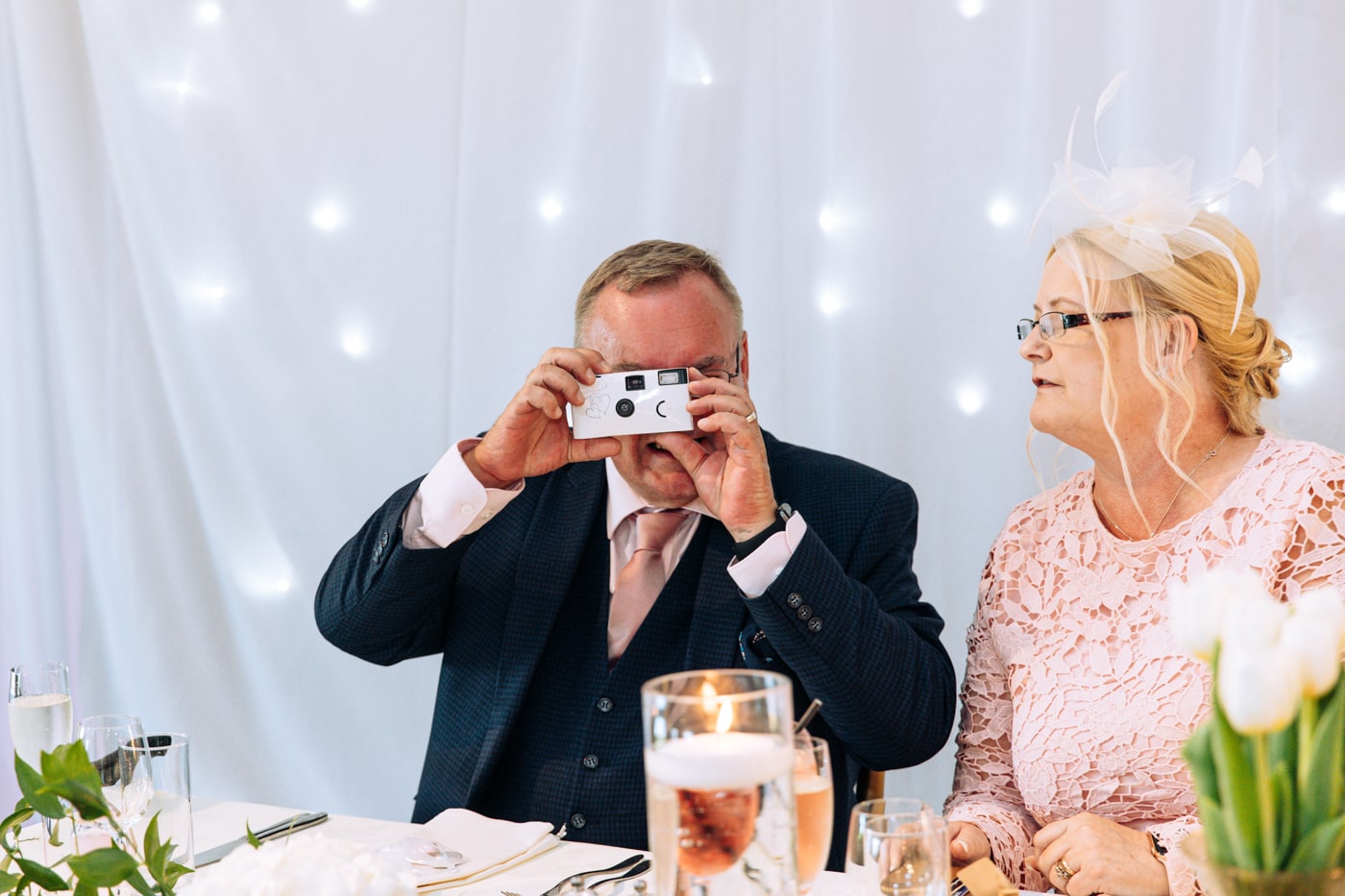 candid wedding photography taken during the speeches and outside in the grounds of heaton house farm in cheshire