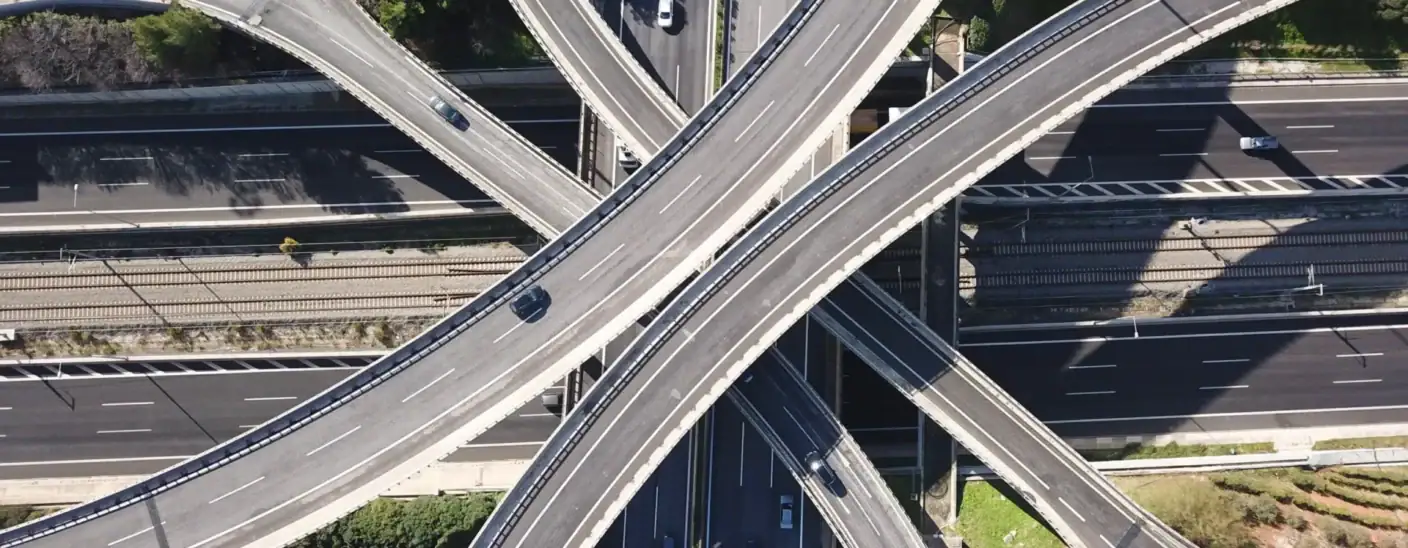 Aerial view of highway interchange with cars traveling on multiple roads in trasport and infrastructure setting