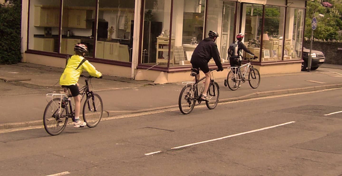 children cycling on a road