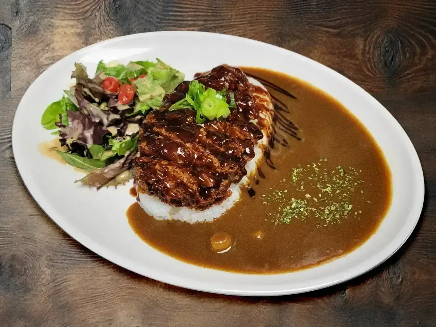 Pork katsu curry with rice and salad at Arcane Maid Café