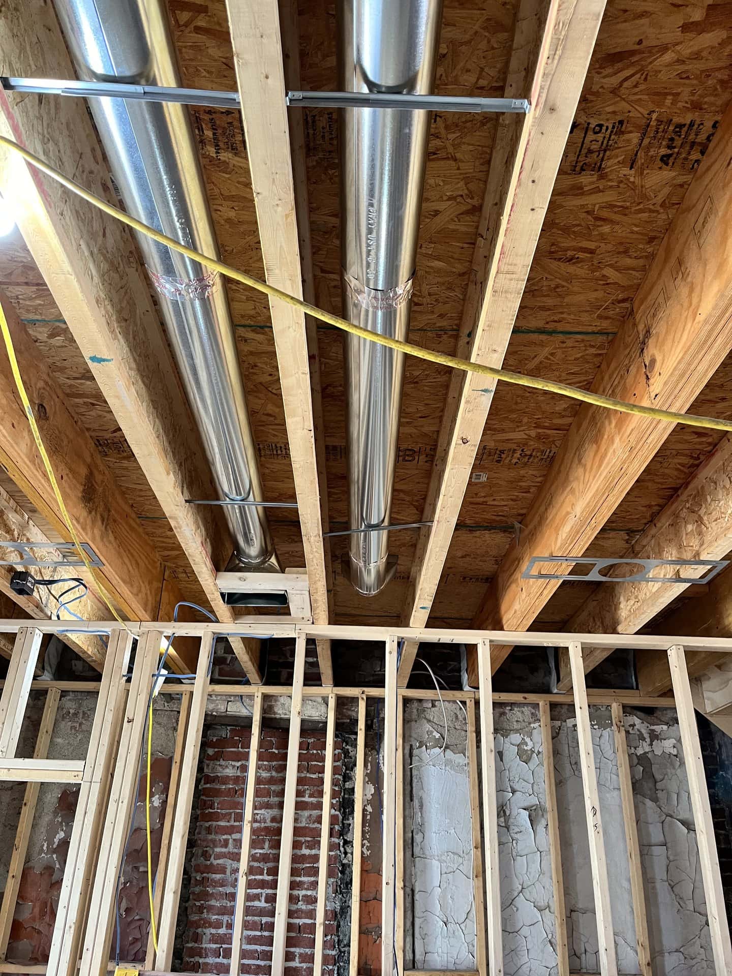 Metal ductwork installed between open ceiling joists