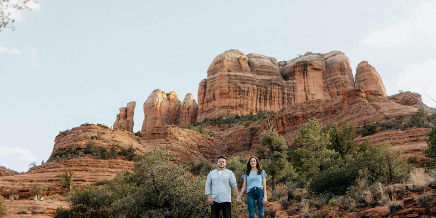 “Romantic couple enjoying a budget-friendly vacation in the USA, with scenic nature views and cozy experiences.”