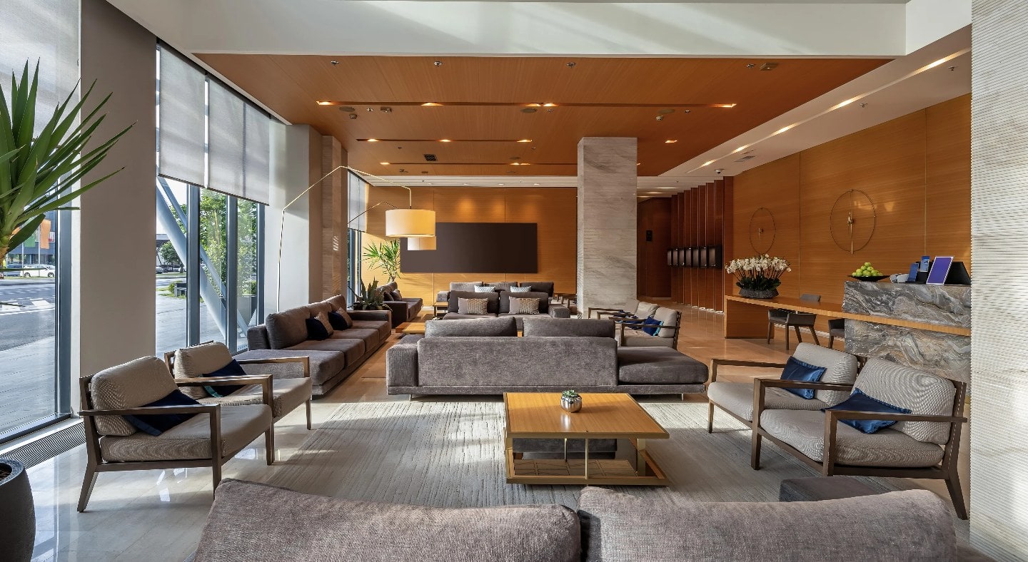 A modern hotel lobby thoughtfully designed by a hotel renovation company with ample natural lighting