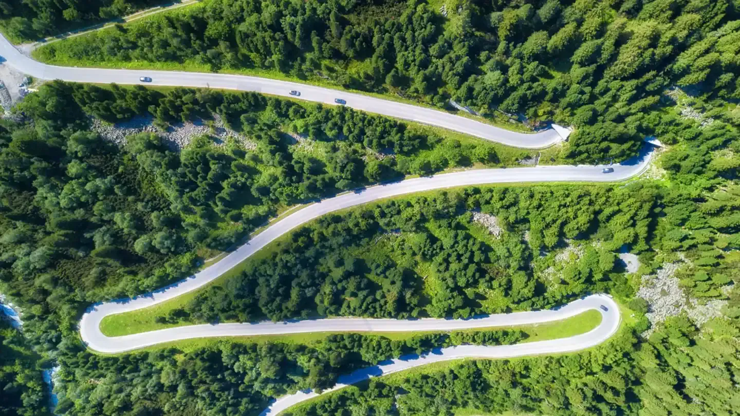 Aerial view of winding mountain road in Asfinag’s video surveillance system project in Austria