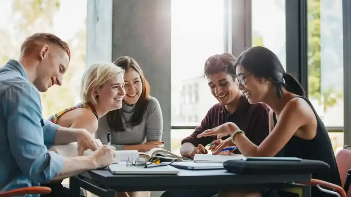 Students studying together at a table in an educational setting