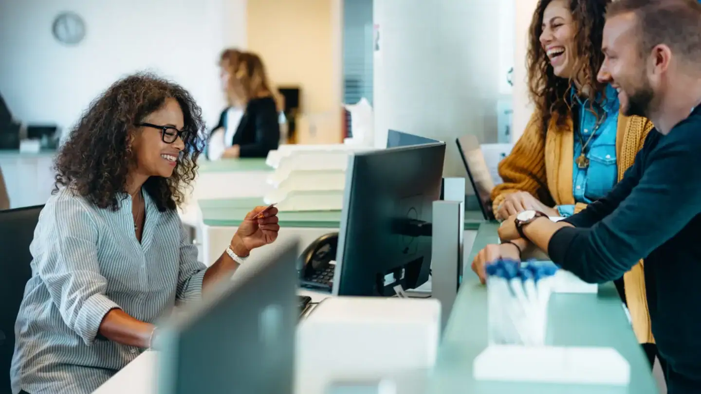 Office workers collaborating at desks in a government office environment supported by IPROTECT