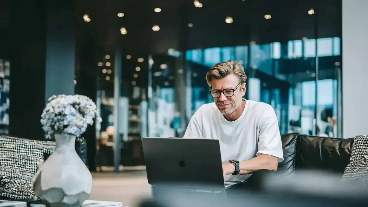 Man using ATLAS application while sitting on a sofa in a modern office space
