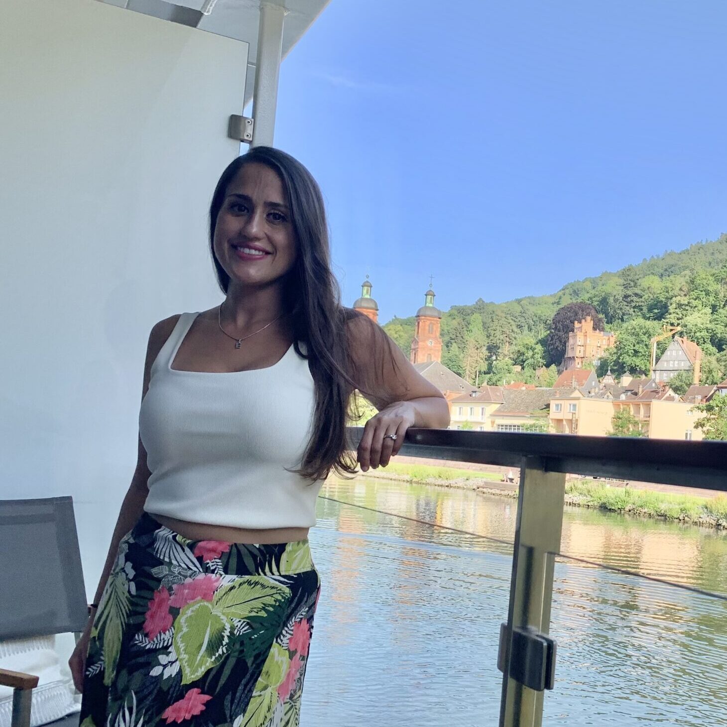 Relaxed woman enjoying scenic river view in Germany, perfect for vacation rentals and travel experiences.