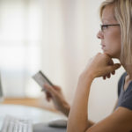 Woman using credit card and computer