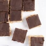 Overhead of squares of vegan millionaire shortbread cookies.